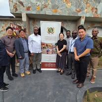 Farmers working in a lush green agricultural field in Ghana